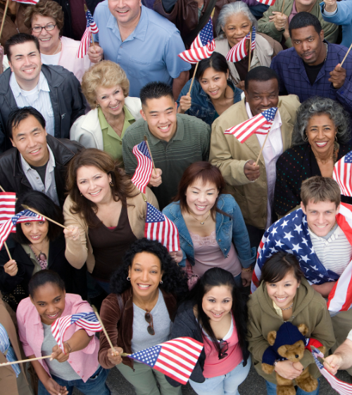 Happy Americans looking up holding flags